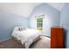 Bedroom with an angled ceiling, one window, and a matching dresser, creating a cozy and inviting atmosphere at 1149 Highway Nc 87, Pittsboro, NC 27312