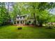 Charming two-story home with a covered front porch, mature trees, and a spacious front yard at 1149 Highway Nc 87, Pittsboro, NC 27312