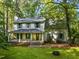 Charming two-story home with a welcoming front porch and lush, mature landscaping at 1149 Highway Nc 87, Pittsboro, NC 27312