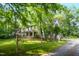 Charming two-story home with a welcoming porch, nestled amidst mature trees for added privacy at 1149 Highway Nc 87, Pittsboro, NC 27312