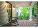 Inviting front porch with a rocking chair and view of the yard at 1149 Highway Nc 87, Pittsboro, NC 27312