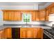 Kitchen with wood cabinets, gray countertops, and stainless steel appliances at 1149 Highway Nc 87, Pittsboro, NC 27312