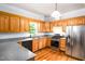 Kitchen featuring wood cabinets, gray countertops, and stainless steel appliances at 1149 Highway Nc 87, Pittsboro, NC 27312