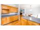 Spacious kitchen featuring wood cabinets, gray countertops, and a view into the adjoining living space at 1149 Highway Nc 87, Pittsboro, NC 27312