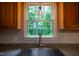 Modern kitchen sink beneath a window with green outdoor views and a stylish pendant light at 1149 Highway Nc 87, Pittsboro, NC 27312