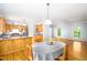 Kitchen with wood cabinets, gray countertops, and view into the dining and living spaces at 1149 Highway Nc 87, Pittsboro, NC 27312