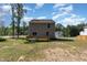 Exterior view of the home showcasing a wooden deck and large backyard at 115 Parkers Gate Dr, Youngsville, NC 27596