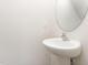 Modern powder room featuring a pedestal sink and a stylish oval mirror at 115 Parkers Gate Dr, Youngsville, NC 27596