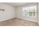 Bedroom featuring a window with blinds and carpeted floors at 115 Parkers Gate Dr, Youngsville, NC 27596