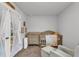 Warm Bedroom featuring a wooden crib, changing table, soft carpet, and decorative accents with french doors at 115 Parkers Gate Dr, Youngsville, NC 27596