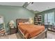Comfortable bedroom features a bed with orange bedding, and a rustic wooden frame at 115 Parkers Gate Dr, Youngsville, NC 27596