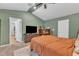 Comfortable bedroom features a bed with orange bedding, rustic wood furniture, and a flat screen television at 115 Parkers Gate Dr, Youngsville, NC 27596