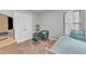 Bright bedroom featuring neutral walls, carpet flooring, closet, and a comfortable green accent chair at 115 Parkers Gate Dr, Youngsville, NC 27596