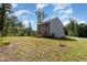 Exterior view of home with a large backyard and wooded area at 115 Parkers Gate Dr, Youngsville, NC 27596