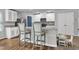 Bright kitchen with stainless steel appliances, granite countertops, and a breakfast bar at 115 Parkers Gate Dr, Youngsville, NC 27596