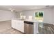 Kitchen island with stainless steel dishwasher and granite countertops; great natural light at 115 Parkers Gate Dr, Youngsville, NC 27596