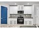 Modern kitchen with stainless steel appliances, mosaic backsplash and blue door at 115 Parkers Gate Dr, Youngsville, NC 27596