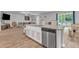 Kitchen island with stainless steel appliances and open living space at 115 Parkers Gate Dr, Youngsville, NC 27596