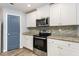 Well-equipped kitchen featuring granite countertops, stainless steel appliances, and ample cabinet space at 115 Parkers Gate Dr, Youngsville, NC 27596