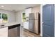 Modern kitchen with stainless steel refrigerator, white cabinets, and granite countertops at 115 Parkers Gate Dr, Youngsville, NC 27596