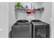 Laundry room with stainless steel washer and dryer and wire shelving at 115 Parkers Gate Dr, Youngsville, NC 27596