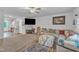 Spacious living room with a plush sectional sofa, ceiling fan, TV, and a play area to the left at 115 Parkers Gate Dr, Youngsville, NC 27596
