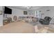 View of living room with plush sectional, area rug, ceiling fan, TV and play area to the left at 115 Parkers Gate Dr, Youngsville, NC 27596