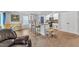 Cozy living room with a modern kitchen, breakfast bar, and hardwood floors at 115 Parkers Gate Dr, Youngsville, NC 27596