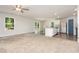 Open-concept living room with lots of natural light and an adjacent modern kitchen at 115 Parkers Gate Dr, Youngsville, NC 27596
