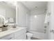 Spotless white bathroom with tub and shower combo, plus a stylish vanity and mirror at 1211 Brown Velvet Ln, Apex, NC 27523