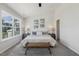 Bedroom featuring a comfortable bed, bedside tables, artwork, and a sun-filled window at 1211 Brown Velvet Ln, Apex, NC 27523
