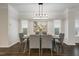 Dining room featuring modern decor, light fixture, hardwood floors, and large windows at 1211 Brown Velvet Ln, Apex, NC 27523