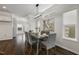 Elegant dining area with modern light fixture, dark hardwood floors, and large windows at 1211 Brown Velvet Ln, Apex, NC 27523