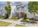 Charming two-story home with a red front door, a small porch, and a beautifully landscaped yard at 1211 Brown Velvet Ln, Apex, NC 27523