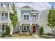 Charming two-story home with a red front door, a small porch, and a beautifully landscaped yard at 1211 Brown Velvet Ln, Apex, NC 27523