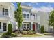 Charming two-story home with a red front door, a small porch, and a beautifully landscaped yard at 1211 Brown Velvet Ln, Apex, NC 27523