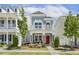Charming two-story home with a red front door, a small porch, and a beautifully landscaped yard at 1211 Brown Velvet Ln, Apex, NC 27523