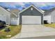 A detached two-car garage with a concrete driveway and blue painted horizontal siding at 1211 Brown Velvet Ln, Apex, NC 27523