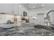 Close up of the kitchen featuring white cabinets and granite countertops, backsplash, and stainless steel appliances at 1211 Brown Velvet Ln, Apex, NC 27523