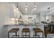 Bright kitchen features white cabinets, granite countertops, stainless steel appliances, and a stylish island with seating at 1211 Brown Velvet Ln, Apex, NC 27523