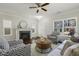 Cozy living room with a fireplace, comfortable seating, and natural light at 1211 Brown Velvet Ln, Apex, NC 27523