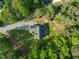 Stunning aerial view of the home showcasing its landscaped yard, private driveway, and lush surrounding forest at 128 Madison Ct, Siler City, NC 27344