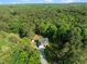 This aerial view captures the home's placement among the lush surrounding forest and well-maintained lawn at 128 Madison Ct, Siler City, NC 27344