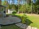 This backyard has a lovely stone paver patio and landscaped area that lead to the backyard shed at 128 Madison Ct, Siler City, NC 27344