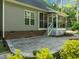 This backyard features a large patio with outdoor lighting at 128 Madison Ct, Siler City, NC 27344