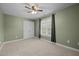 This room has a ceiling fan, a large window and closet doors at 128 Madison Ct, Siler City, NC 27344