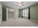 Spacious bedroom with plush carpeting, neutral walls, walk-in closet, and natural light from window at 128 Madison Ct, Siler City, NC 27344