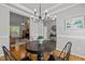 Formal dining room with wood floors, a chandelier, and an open view of the living room at 128 Madison Ct, Siler City, NC 27344