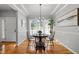 Dining room featuring a chandelier, wood floors and natural light from the nearby window at 128 Madison Ct, Siler City, NC 27344