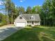 This charming single-Gathering home boasts a two-car garage, inviting front porch, and well-manicured lawn at 128 Madison Ct, Siler City, NC 27344